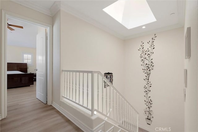 2613 Carnegie Ln # B, Redondo Beach, CA 90278 - hall featuring a skylight, light wood-style flooring, crown molding, an upstairs landing, and recessed lighting