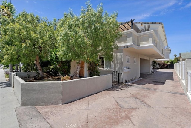 2613 Carnegie Ln # B, Redondo Beach, CA 90278 - view of side of home featuring a fenced front yard, a gate, and stucco siding