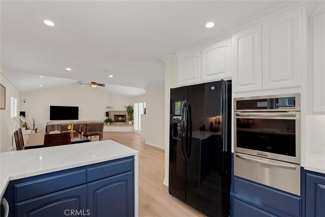 2613 Carnegie Ln # B, Redondo Beach, CA 90278 - kitchen with black fridge, oven, a warming drawer, blue cabinetry, and light wood-type flooring