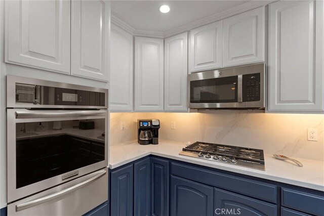 2613 Carnegie Ln # B, Redondo Beach, CA 90278 - kitchen with stainless steel appliances, blue cabinets, a warming drawer, white cabinets, and recessed lighting