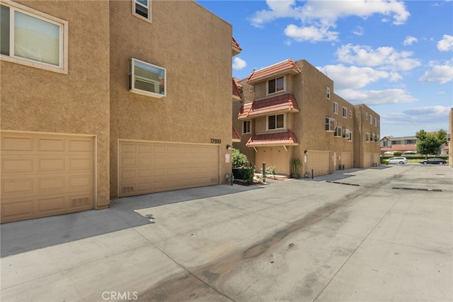 17910 River Cir Unit 1, Canyon Country, CA 91387 - view of building exterior featuring a garage and a residential view