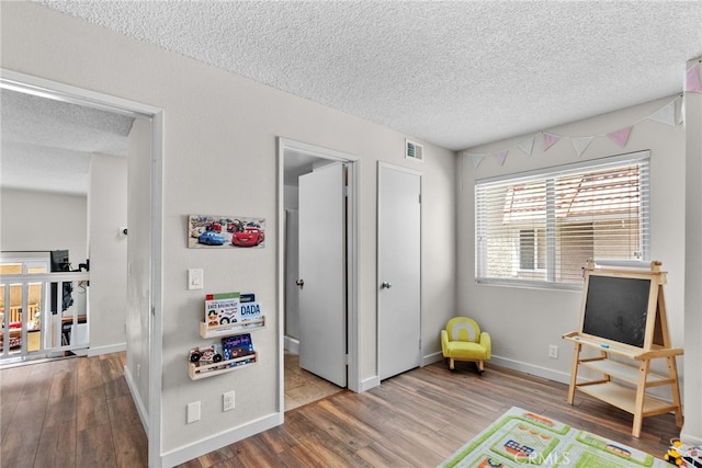 17910 River Cir Unit 1, Canyon Country, CA 91387 - game room with a textured ceiling and wood finished floors