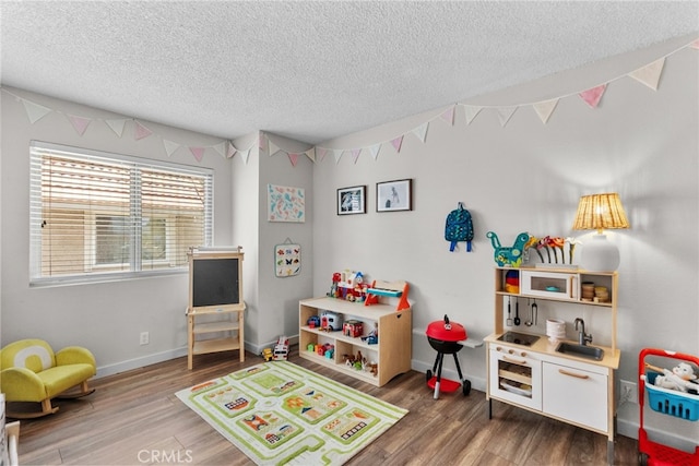 17910 River Cir Unit 1, Canyon Country, CA 91387 - recreation room with a textured ceiling and wood finished floors