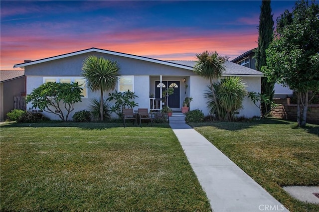429 S Colfax St, La Habra, CA 90631 - view of front facade featuring a lawn, stucco siding, and a porch