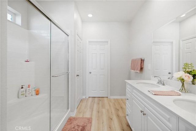 25541 Buckeye Meadow Ln, Homeland, CA 92548 - full bath featuring wood finished floors, a shower stall, double vanity, and recessed lighting