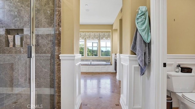 10 Calle Castillo, San Clemente, CA 92673 - bathroom featuring a bath, a shower stall, and wainscoting