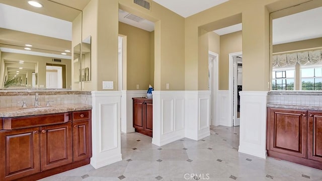 10 Calle Castillo, San Clemente, CA 92673 - bathroom with vanity, a decorative wall, a wainscoted wall, backsplash, and recessed lighting
