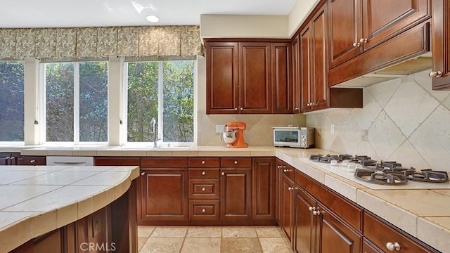 10 Calle Castillo, San Clemente, CA 92673 - kitchen featuring white gas stovetop, tile counters, and decorative backsplash