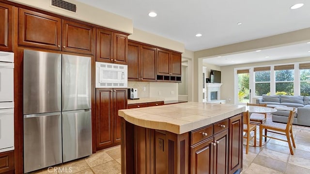 10 Calle Castillo, San Clemente, CA 92673 - kitchen with freestanding refrigerator, white microwave, tile countertops, recessed lighting, and open floor plan
