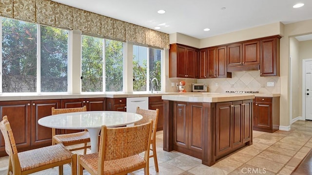10 Calle Castillo, San Clemente, CA 92673 - kitchen featuring decorative backsplash, light countertops, under cabinet range hood, a kitchen island, and recessed lighting
