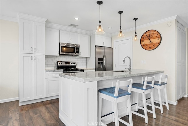 17700 Palo Verde Ave, Cerritos, CA 90703 - kitchen with stainless steel appliances, a kitchen breakfast bar, dark wood finished floors, white cabinets, and recessed lighting