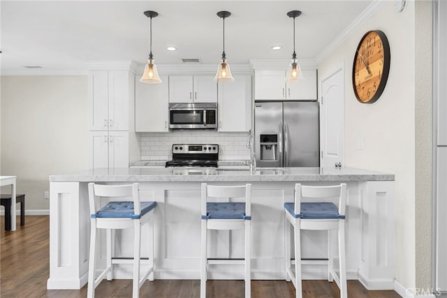 17700 Palo Verde Ave, Cerritos, CA 90703 - kitchen featuring appliances with stainless steel finishes, backsplash, white cabinets, a kitchen breakfast bar, and ornamental molding