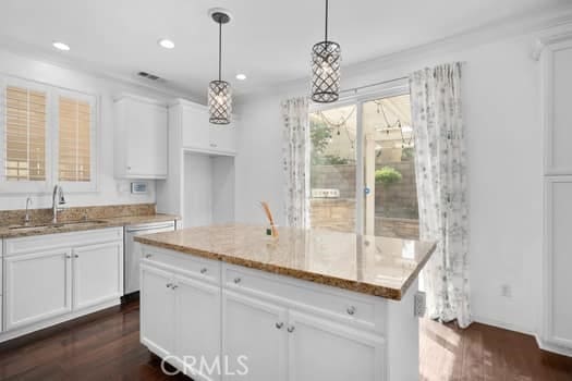 252 W Tulip Tree Ave, Orange, CA 92865 - kitchen with light stone countertops, white cabinetry, dark wood-style flooring, stainless steel dishwasher, and recessed lighting