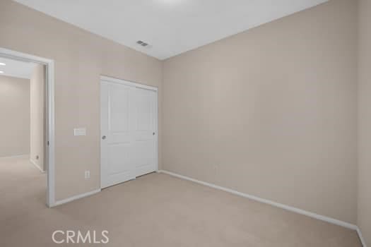 252 W Tulip Tree Ave, Orange, CA 92865 - unfurnished bedroom with light colored carpet and a closet