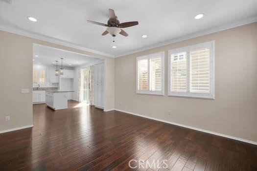 252 W Tulip Tree Ave, Orange, CA 92865 - unfurnished living room featuring crown molding, dark wood-type flooring, a ceiling fan, and recessed lighting
