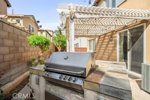 252 W Tulip Tree Ave, Orange, CA 92865 - fenced backyard featuring an outdoor kitchen and a pergola