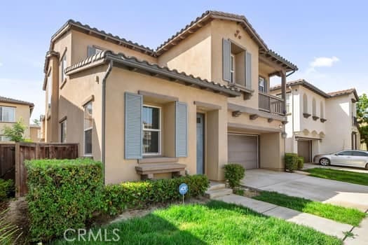 252 W Tulip Tree Ave, Orange, CA 92865 - view of front facade featuring a garage, concrete driveway, stucco siding, and a balcony