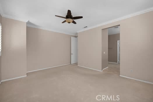 252 W Tulip Tree Ave, Orange, CA 92865 - spare room featuring crown molding, ceiling fan, and light carpet