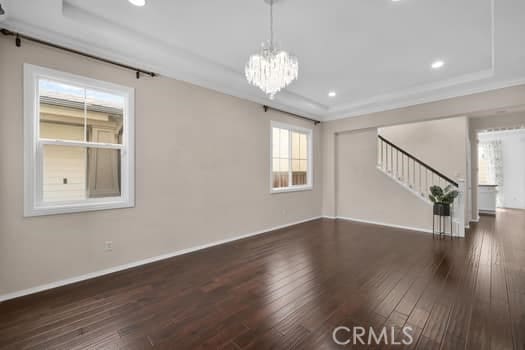 252 W Tulip Tree Ave, Orange, CA 92865 - unfurnished living room with a tray ceiling, hardwood / wood-style flooring, stairway, and recessed lighting