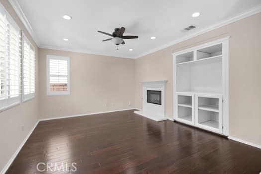 252 W Tulip Tree Ave, Orange, CA 92865 - unfurnished living room with ornamental molding, wood finished floors, ceiling fan, a glass covered fireplace, and recessed lighting