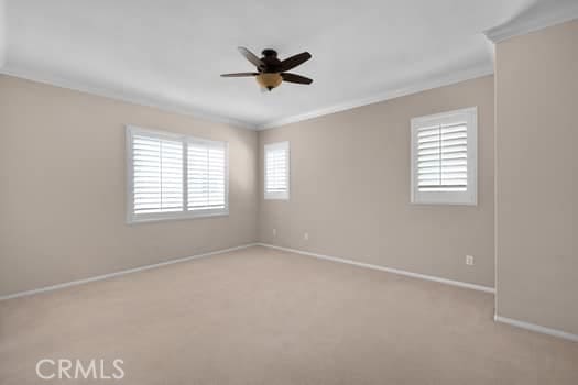 252 W Tulip Tree Ave, Orange, CA 92865 - unfurnished room with ornamental molding, ceiling fan, and light colored carpet