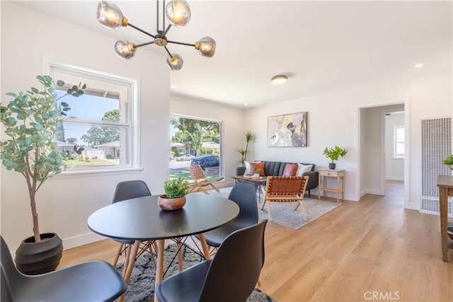 10536 La Mirada Blvd, Whittier, CA 90604 - dining room with a chandelier, a heating unit, plenty of natural light, and light wood-style flooring