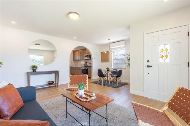 10536 La Mirada Blvd, Whittier, CA 90604 - living room featuring arched walkways, light wood-style floors, a chandelier, and recessed lighting