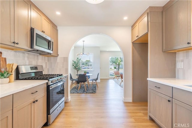 10536 La Mirada Blvd, Whittier, CA 90604 - kitchen featuring appliances with stainless steel finishes, arched walkways, light wood finished floors, light brown cabinets, and recessed lighting
