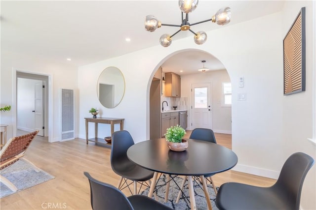 10536 La Mirada Blvd, Whittier, CA 90604 - dining area featuring a heating unit, arched walkways, a chandelier, light wood finished floors, and recessed lighting