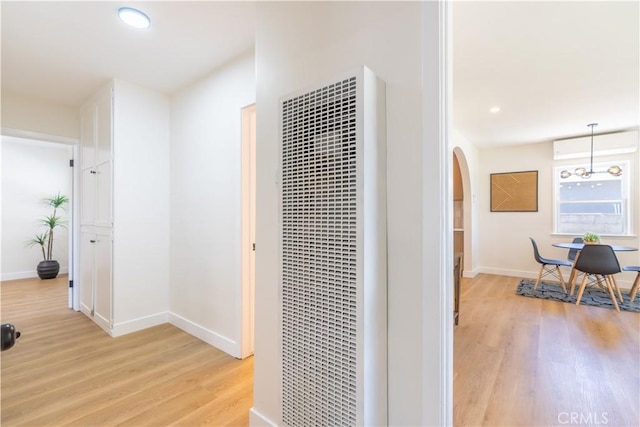 10536 La Mirada Blvd, Whittier, CA 90604 - corridor featuring a heating unit, light wood-style floors, arched walkways, and recessed lighting