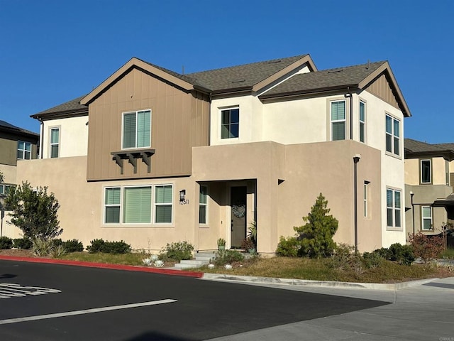 12611 Stella Ln, San Diego, CA 92129 - view of front facade featuring a shingled roof and stucco siding