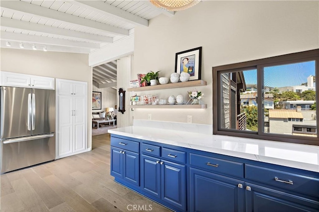 33942 Pequito Dr, Dana Point, CA 92629 - kitchen featuring freestanding refrigerator, blue cabinetry, light wood-style floors, open shelves, and light countertops