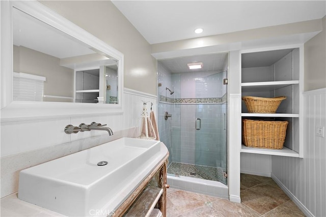 33942 Pequito Dr, Dana Point, CA 92629 - bathroom with a shower stall, vanity, wainscoting, tile patterned flooring, and a decorative wall