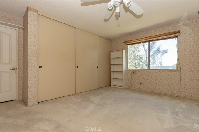 27021 Moro Azul, Mission Viejo, CA 92691 - unfurnished bedroom with wallpapered walls, carpet flooring, a closet, and a ceiling fan