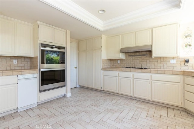 27021 Moro Azul, Mission Viejo, CA 92691 - kitchen with stainless steel double oven, white dishwasher, under cabinet range hood, ornamental molding, and tile countertops
