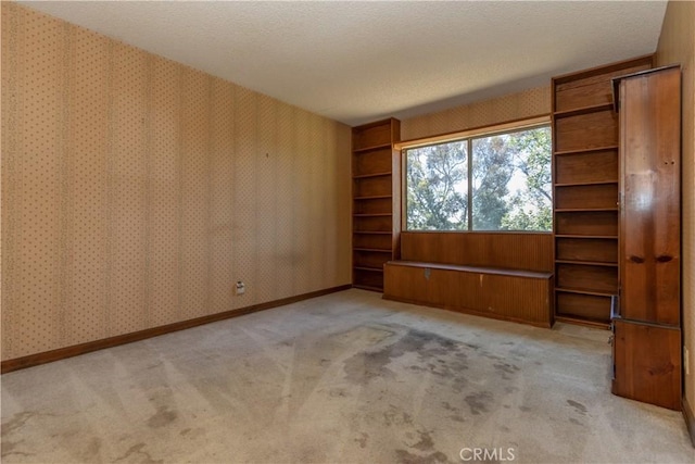 27021 Moro Azul, Mission Viejo, CA 92691 - carpeted empty room with a textured ceiling, wallpapered walls, and built in features