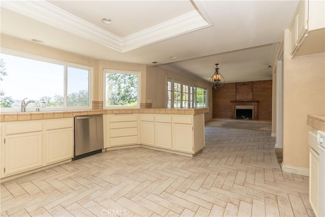 27021 Moro Azul, Mission Viejo, CA 92691 - kitchen with stainless steel dishwasher, tile countertops, a large fireplace, crown molding, and open floor plan