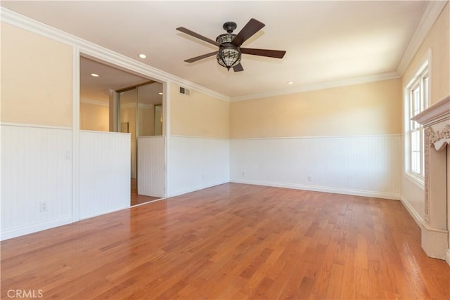 27021 Moro Azul, Mission Viejo, CA 92691 - empty room with wainscoting, a ceiling fan, wood finished floors, and ornamental molding