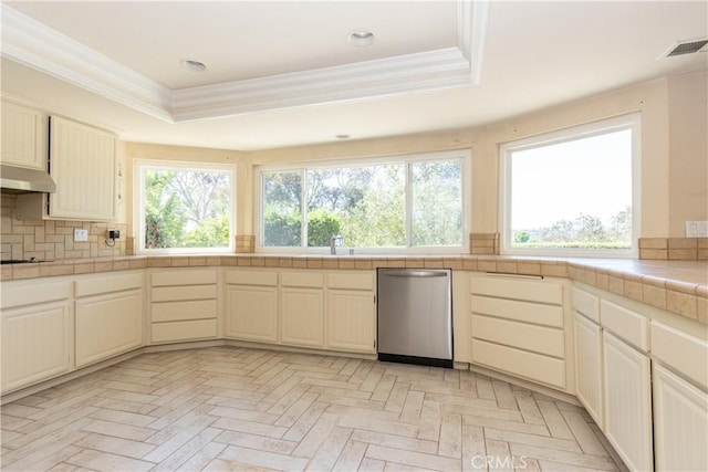 27021 Moro Azul, Mission Viejo, CA 92691 - kitchen with stainless steel dishwasher, a tray ceiling, tile countertops, ornamental molding, and backsplash