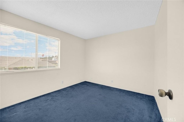 4510 E Hightree Cir, Anaheim, CA 92807 - spare room featuring dark carpet and a textured ceiling