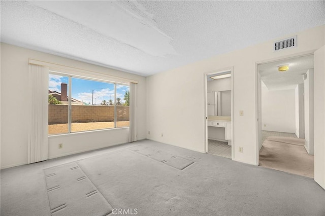 4510 E Hightree Cir, Anaheim, CA 92807 - unfurnished bedroom featuring carpet floors, a textured ceiling, and ensuite bathroom