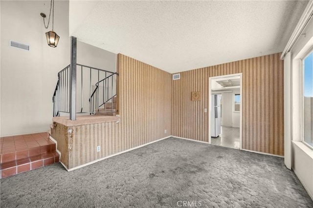 4510 E Hightree Cir, Anaheim, CA 92807 - unfurnished living room featuring carpet flooring, a textured ceiling, and stairway