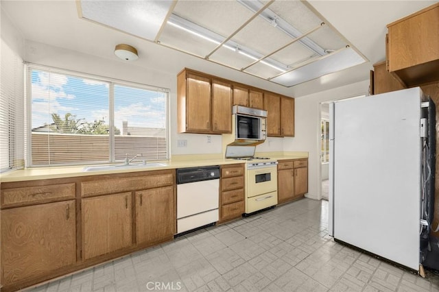 4510 E Hightree Cir, Anaheim, CA 92807 - kitchen with white appliances, light countertops, and brown cabinets