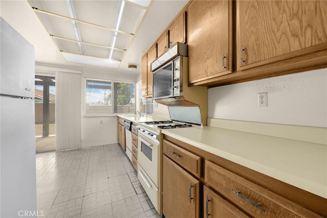 4510 E Hightree Cir, Anaheim, CA 92807 - kitchen with white appliances, light countertops, and brown cabinets