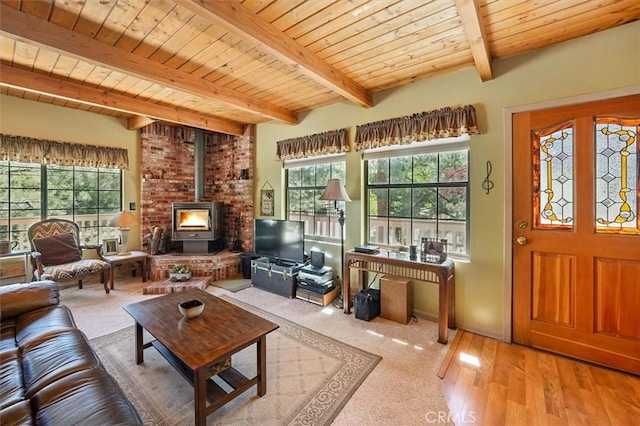 2229 Birchwood Way, Pine Mountain Club, CA 93222 - living area with a wood stove, healthy amount of natural light, a wooden ceiling with exposed beams, and wood finished floors