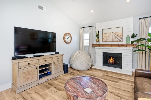 1851 Valencia Ave, Carlsbad, CA 92008 - living room featuring vaulted ceiling, light wood-style floors, a brick fireplace, and recessed lighting