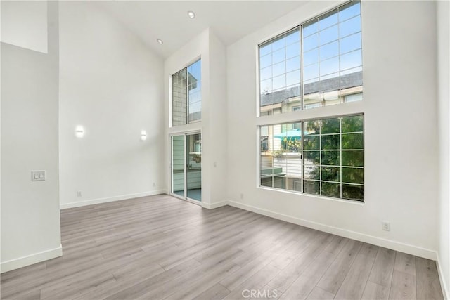 11150 Glenoaks Blvd Unit 106, Pacoima, CA 91331 - empty room with high vaulted ceiling and wood finished floors