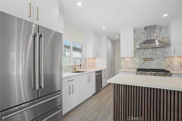 1230 Spazier Ave, Glendale, CA 91201 - kitchen with appliances with stainless steel finishes, wall chimney exhaust hood, light countertops, tasteful backsplash, and recessed lighting