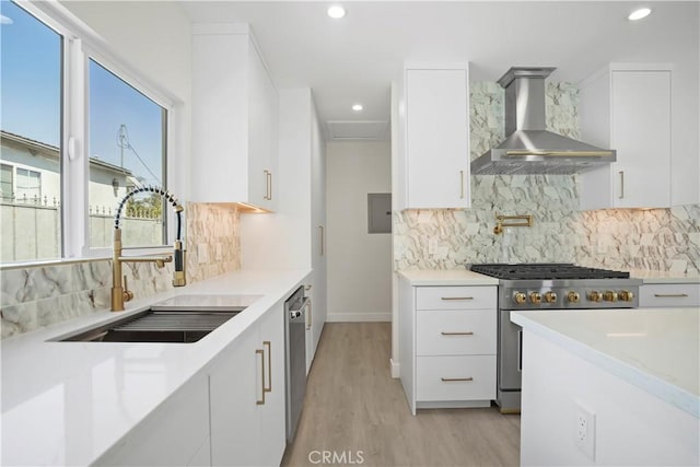 1230 Spazier Ave, Glendale, CA 91201 - kitchen featuring wall chimney range hood, stainless steel appliances, light wood-style flooring, modern cabinets, and recessed lighting