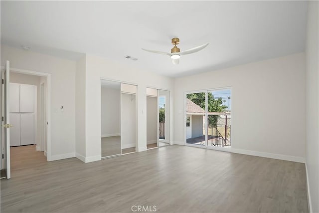 1230 Spazier Ave, Glendale, CA 91201 - unfurnished bedroom with light wood finished floors, two closets, access to outside, and a ceiling fan